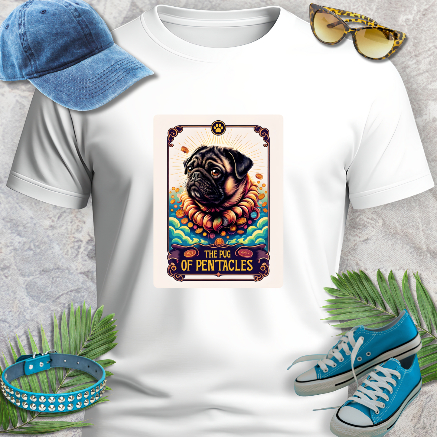 White t-shirt with a graphic of a pug and text, surrounded by a blue cap, sunglasses, blue sneakers, and green leaves on a gray background.
