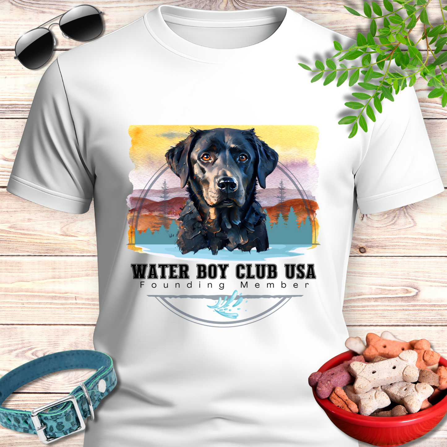 White t-shirt with a black dog graphic and 'Water Boy Club USA' text on a wooden surface with pet accessories.