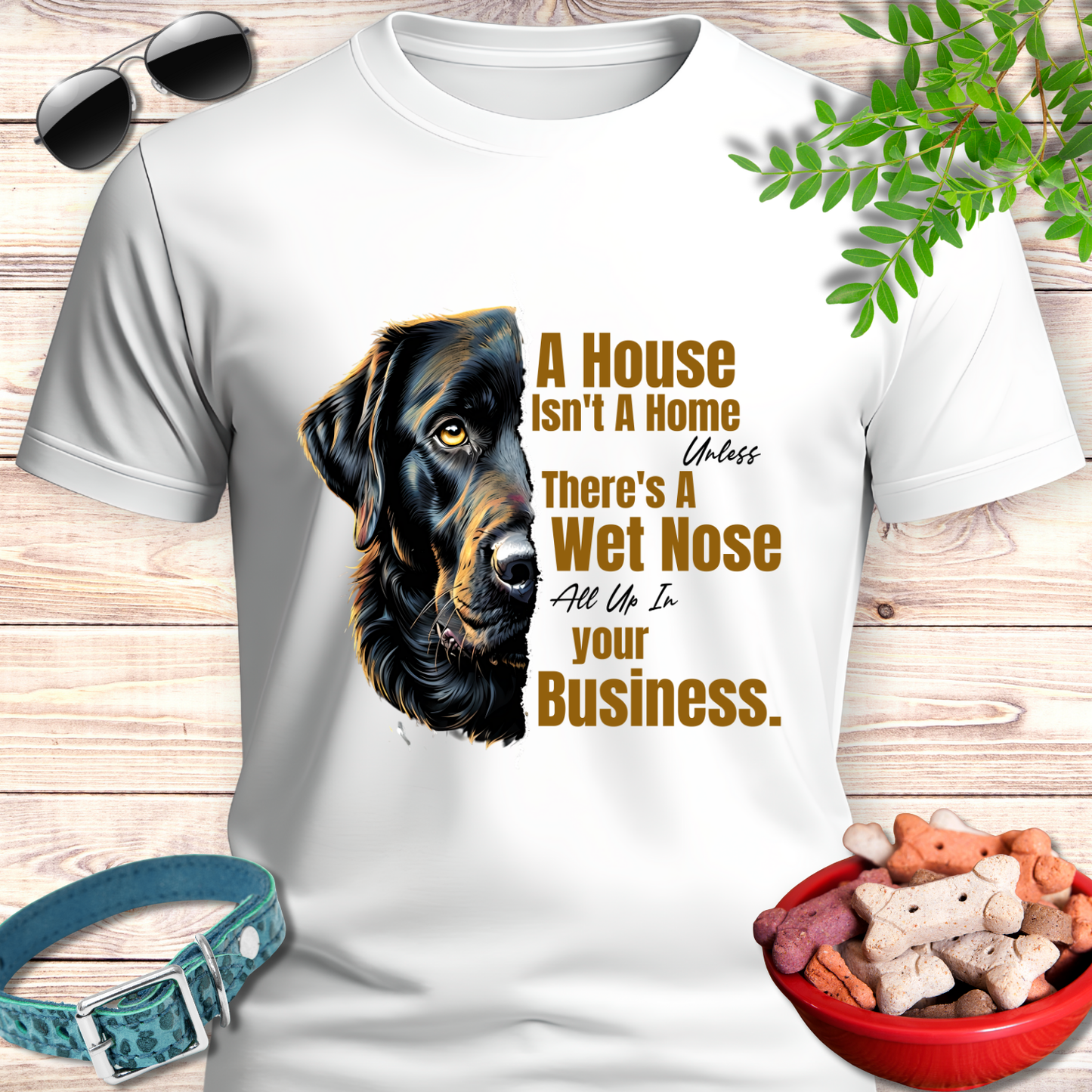 White t-shirt with a dog graphic and text on a wooden surface with pet accessories.