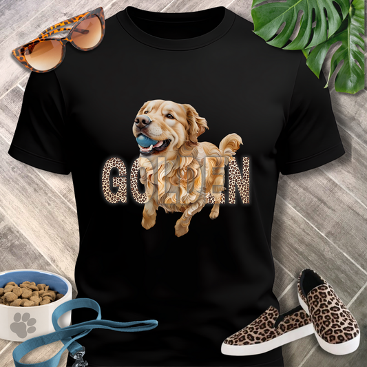 Black t-shirt with a golden retriever graphic and 'GOO'IN' text, surrounded by sunglasses, shoes, and pet food.