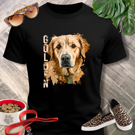 Black t-shirt with a golden retriever graphic, surrounded by pet accessories on a wooden surface.
