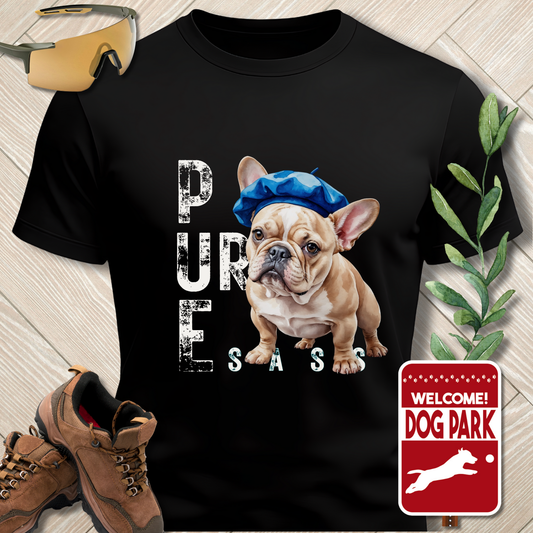 Black t-shirt with a dog graphic and text on a wooden surface with shoes and a plant.