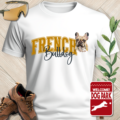 White t-shirt with 'French Bulldog' design, brown boots, and 'Welcome to the Dog Park' sign on a wooden surface.
