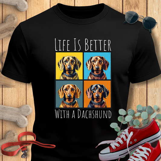 Black t-shirt with dachshund design and text 'Life is better with a dachshund' on a wooden background.