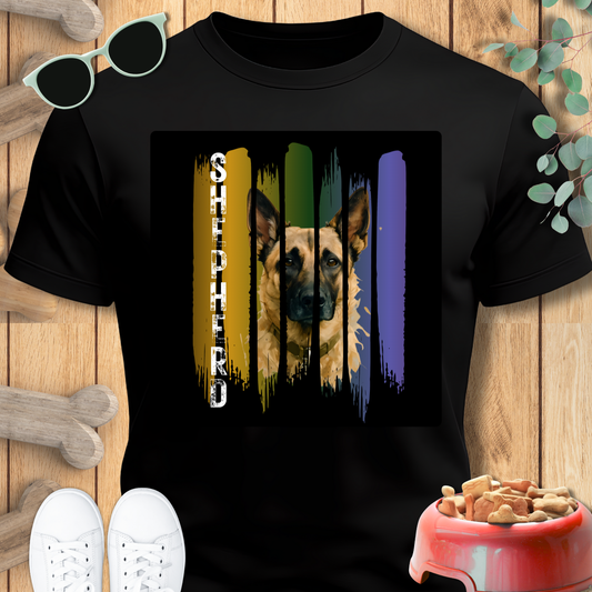 Black t-shirt with a dog graphic and 'Shepherd' text on a wooden surface with pet accessories.