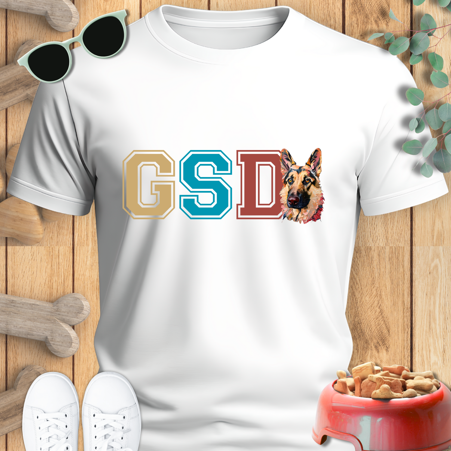 White t-shirt with 'GSD' letters and a German Shepherd graphic on a wooden surface.
