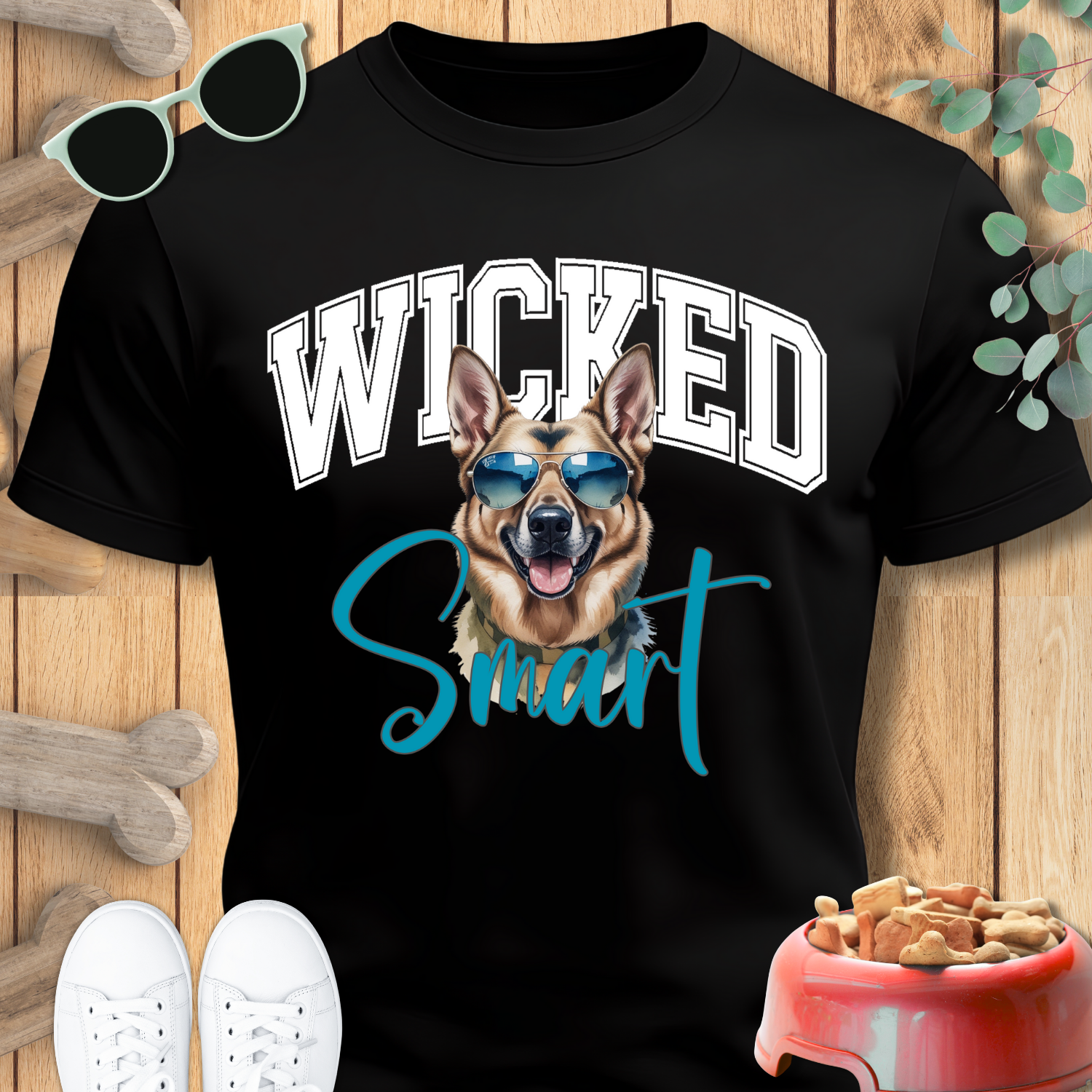 Black t-shirt with a dog graphic and 'Wicked Smart' text on a wooden surface.
