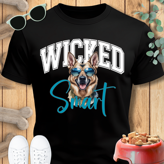 Black t-shirt with a dog graphic and 'Wicked Smart' text on a wooden surface.