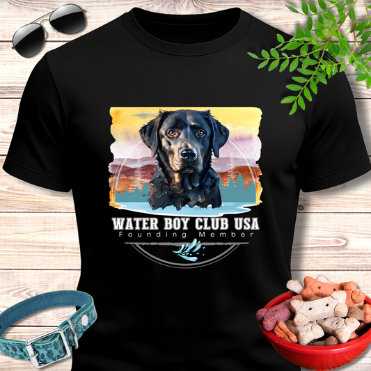 Black t-shirt with a dog graphic and 'Water Boy Club USA' text on a wooden surface with accessories.
