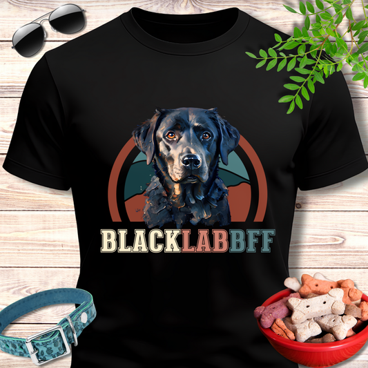 Black t-shirt with a black lab graphic and 'BLACK LAB BFF' text on a wooden surface with pet accessories.