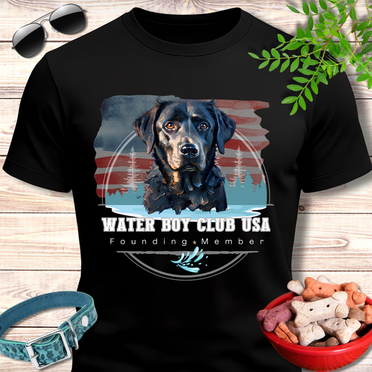 Black t-shirt with a dog graphic and text on a wooden surface with accessories.