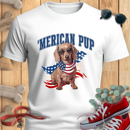 Dachshund shirt with 'Merican Pup in White featuring a dachshund, sunglasses, red sneakers, and a wooden background.