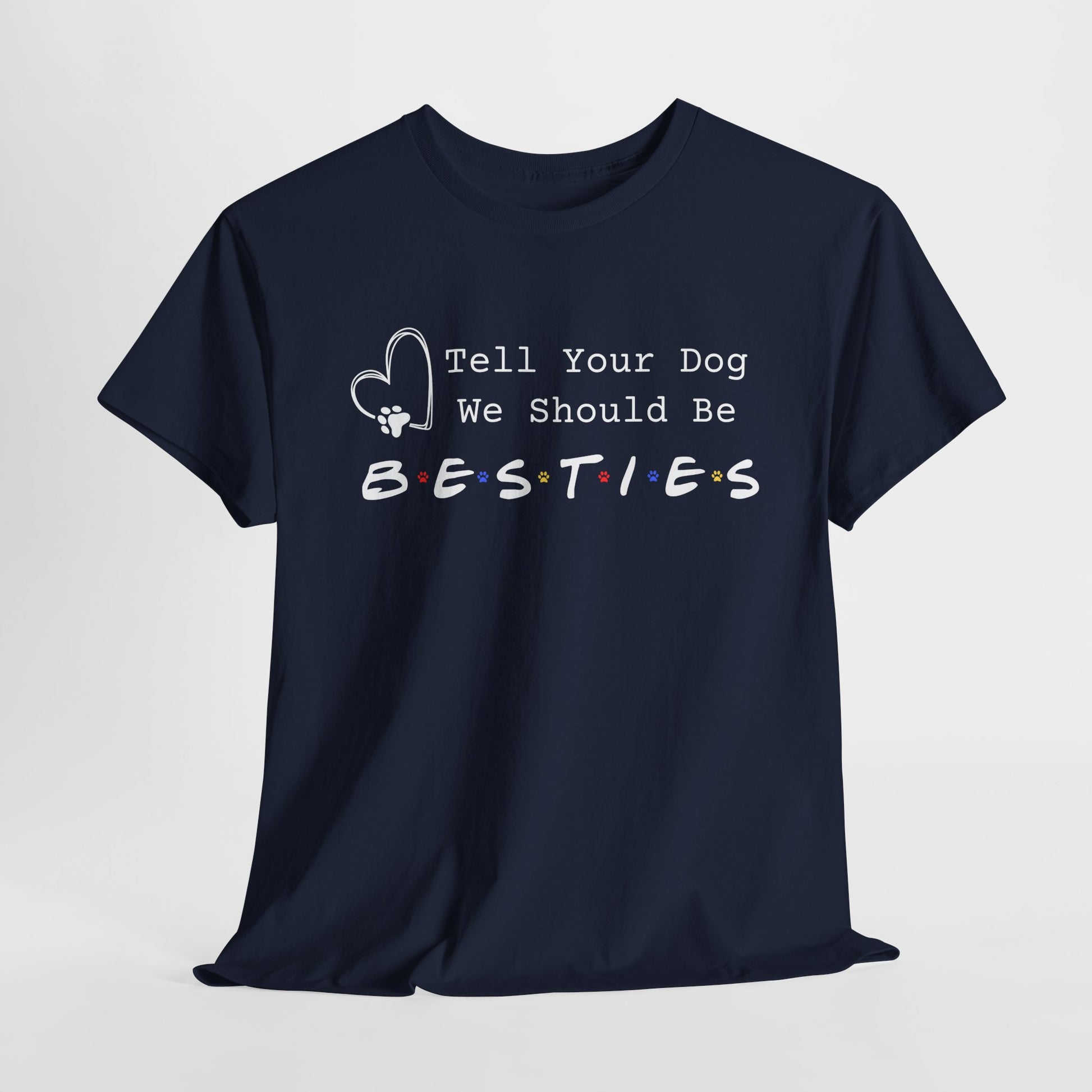 Navy blue t-shirt with white text 'Tell Your Dog We Should Be Besties' on a light gray background