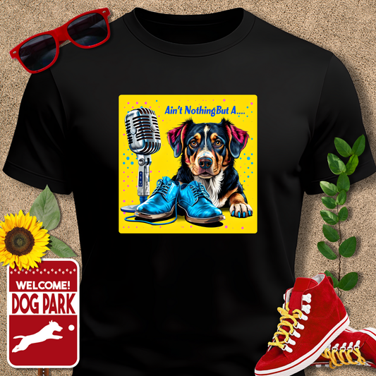 Black dog love tshirte with a colorful graphic of a dog, microphone, and shoes on a beige background.