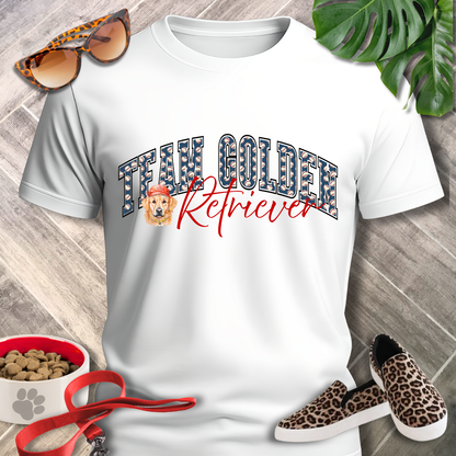 White t-shirt with 'Team Golden Retriever' design, leopard print sunglasses, sneakers, and pet food bowl on a wooden surface.