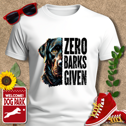 Zero-barks-crazydog t shirts in White with dog graphic and 'Zero Barks Given' text, sunglasses, red sneakers, sunflower, and 'Welcome to the Dog Park' sign on a textured background.